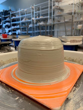 Load image into Gallery viewer, The clay is centered on the wheel.