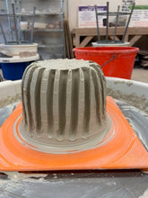 Load image into Gallery viewer, Trenches are cut out of the centered clay.