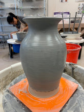 Load image into Gallery viewer, When you throw, your hands must be wet to prevent friction. This photo shows how liquid clay forms all over the vase. This vase is clearly not the vase in this listing.  But the  process is the same.