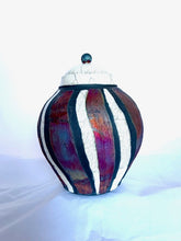 Load image into Gallery viewer, The beauty of the raku process can be seen in the color variation in the copper stripes.
